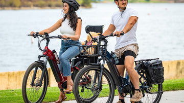 A couple rides Himiway A7 e-bikes along a lakeside path — one bike fitted with a child seat, perfect for family outings