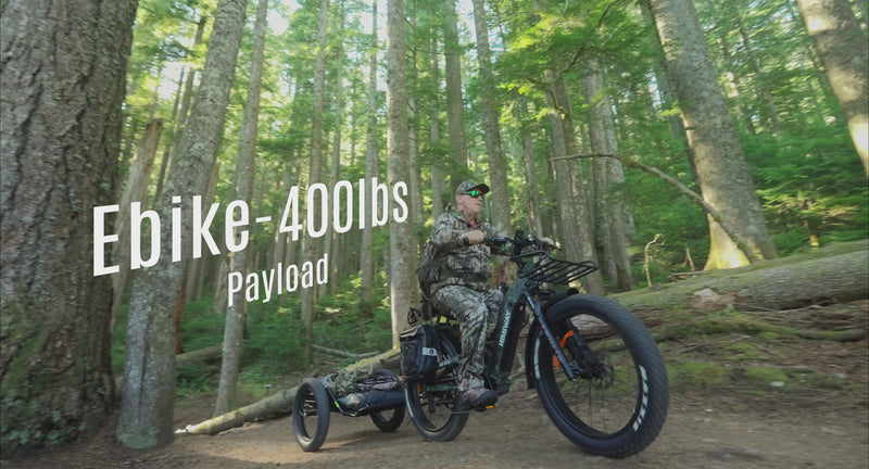Himiway D5 2.0 Camo riding through forest trails with a cargo trailer and crossing shallow water
